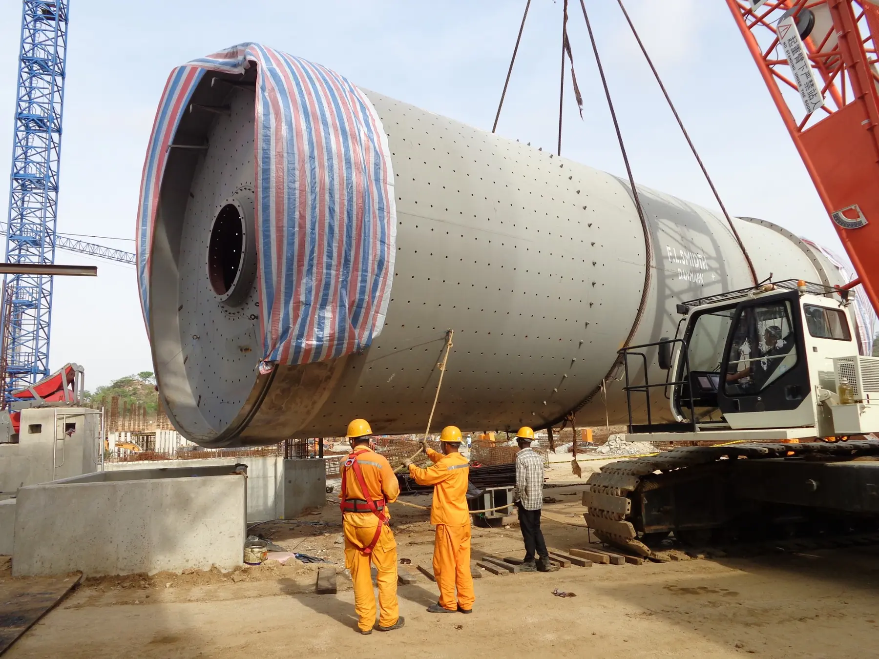 Large cement mill shell lifted into position during erection